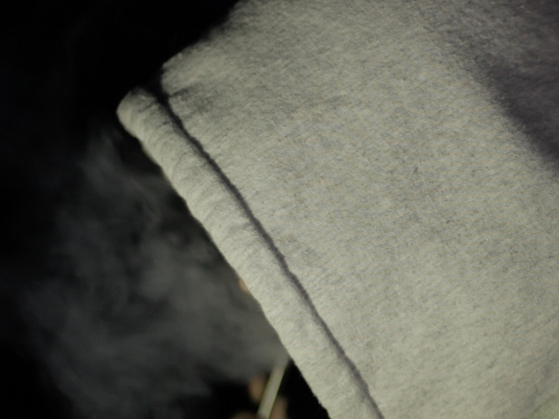 A highschool student vapes at nighttime