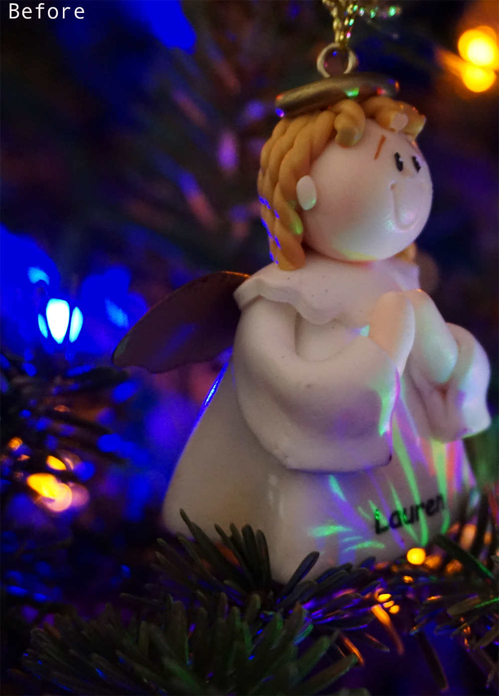 a christmas angel ornament in a tree in color
