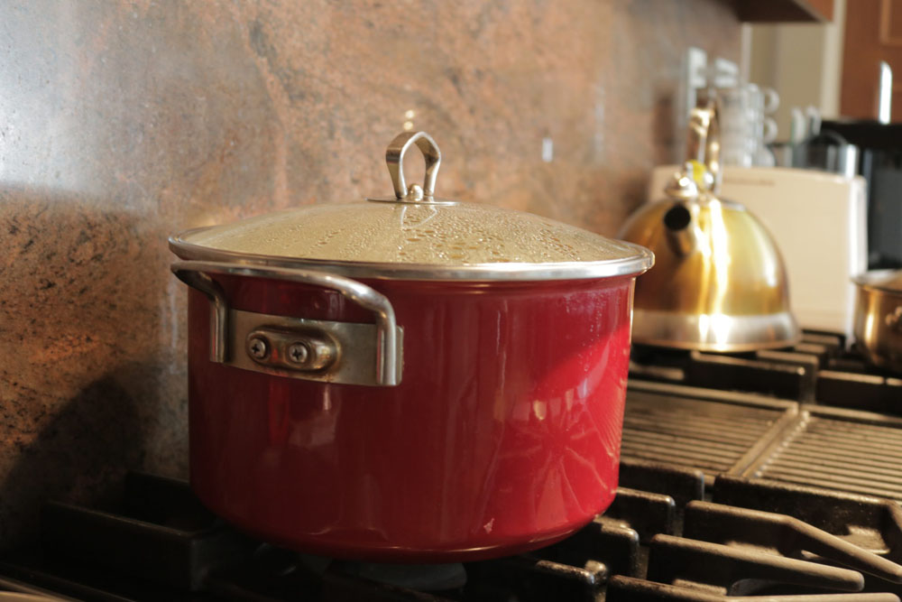 A red pot on a stove.