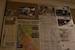 A large wall of newspaper articles dicatating the status of disasters occuring.