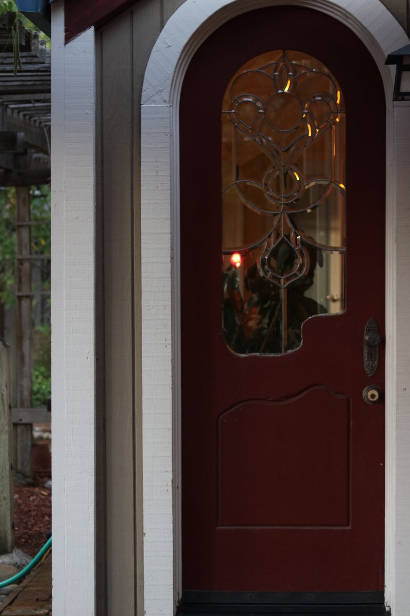 Red arched door which glass details.