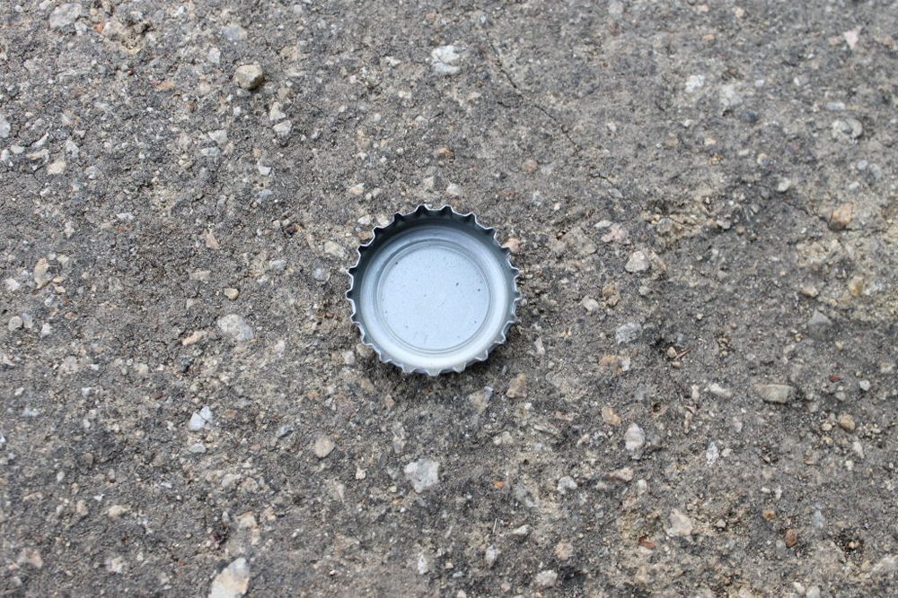 a glass soda cap in the center on the ground