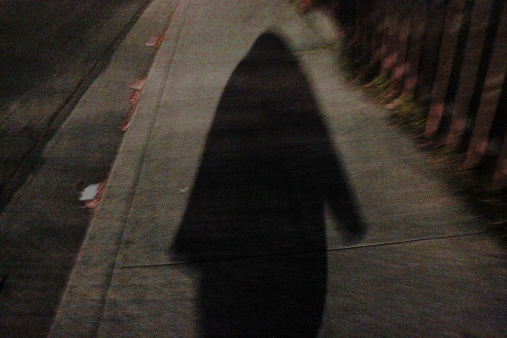 sidewalk and hooded shadow
