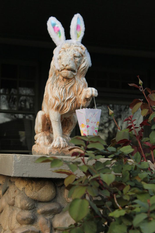 lion statue with bunny ears and a basket