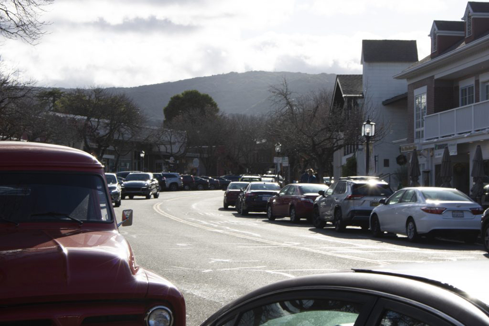 An image of main street in Los Altos, lined by cars on either side. In the distance are the Los Altos Hills.