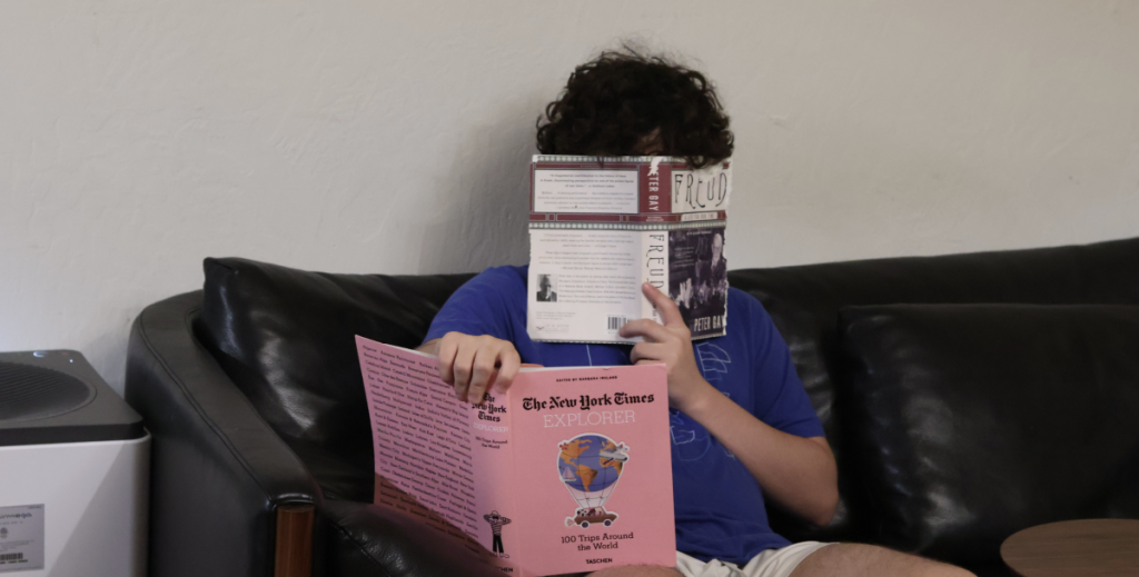 A photo of me with a book on my lap and a book right in front of my eyes which covers my beautiful face.