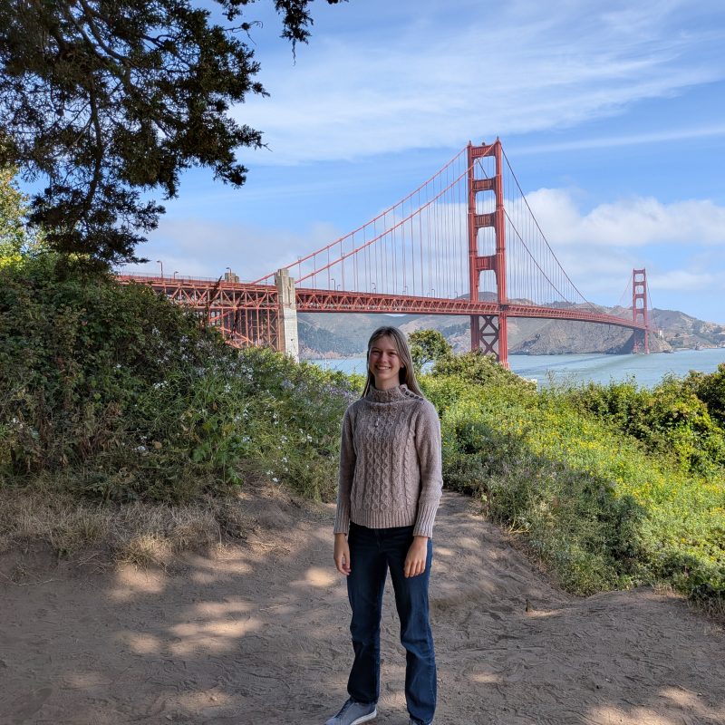 Olivia Barlow in front of the Golden Gate Bridge