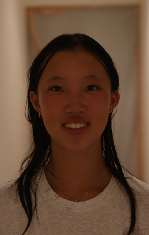 Face of a girl smiling at a camera.