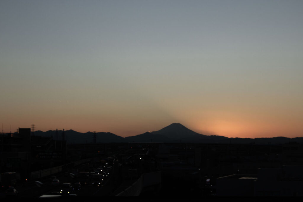 a photo of Mt. Fuji at sunset from far away.