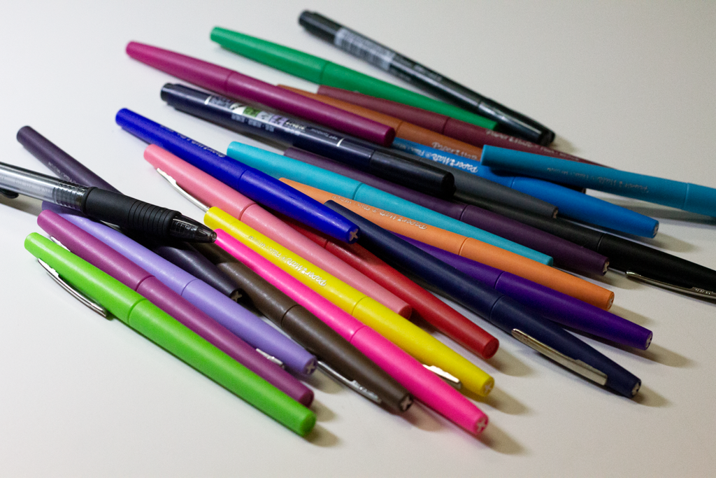 Colorful pens laid out in a disorganized way
