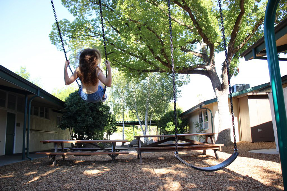 Photo of the rule of thirds that shows motion. The photo shows a girl on a swing swinging.
