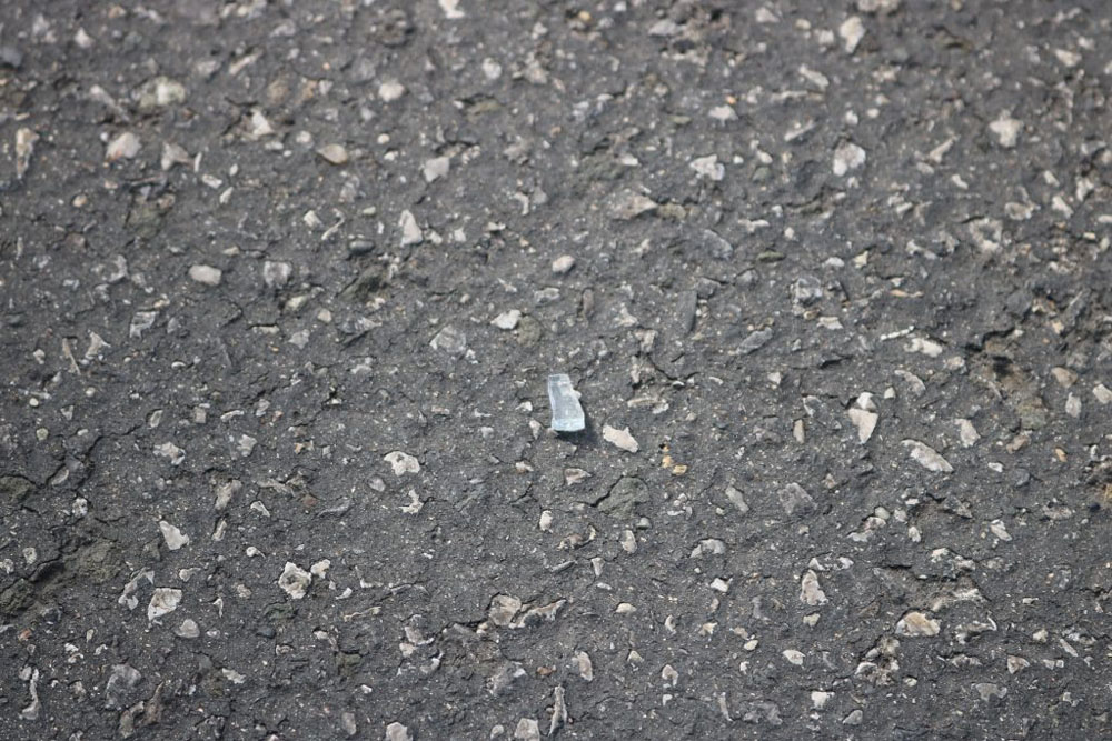 Photo that represents me.  The photo shows a piece of glass on pavement.