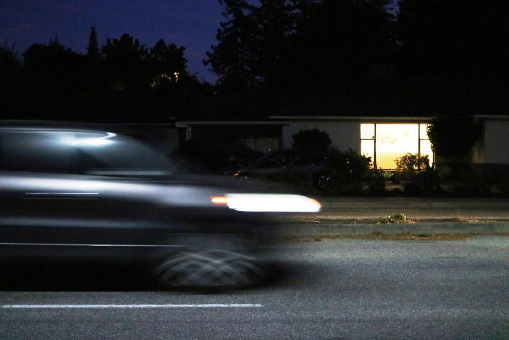 Photo of Rule of Thirds that shows motion.  The photo is of a car driving past a house at night.