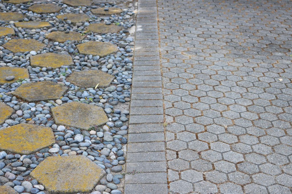 A picture of some stepping stones and a part of a driveway.