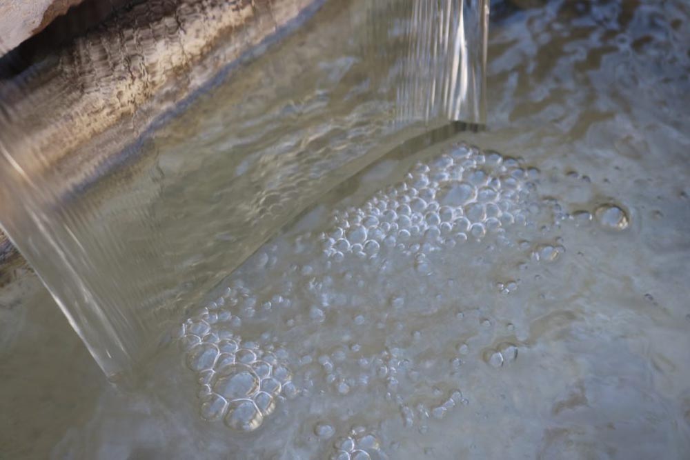 A photo of a small waterfall in a fountain.