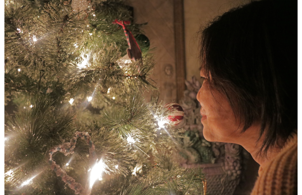 my mom in front of our Christmas tree.