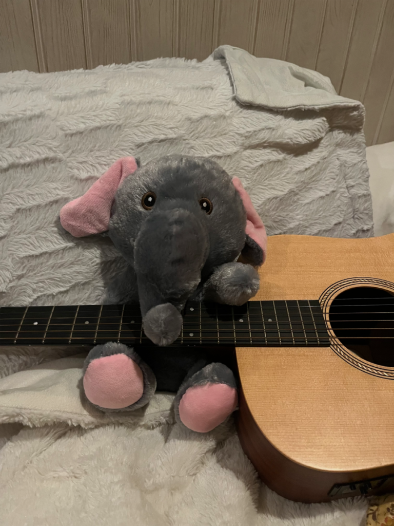 This image has an empty alt attribute; its file name is elephant-guitar-1-768x1024.png