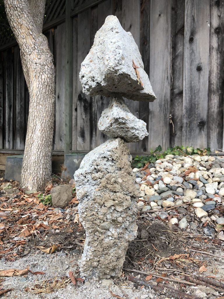Three jagged concrete rocks stacked on top of each other