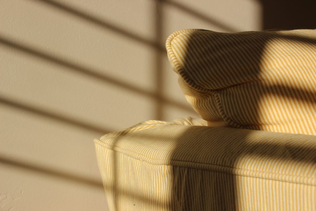 Sunlight forms shadows on a wall.