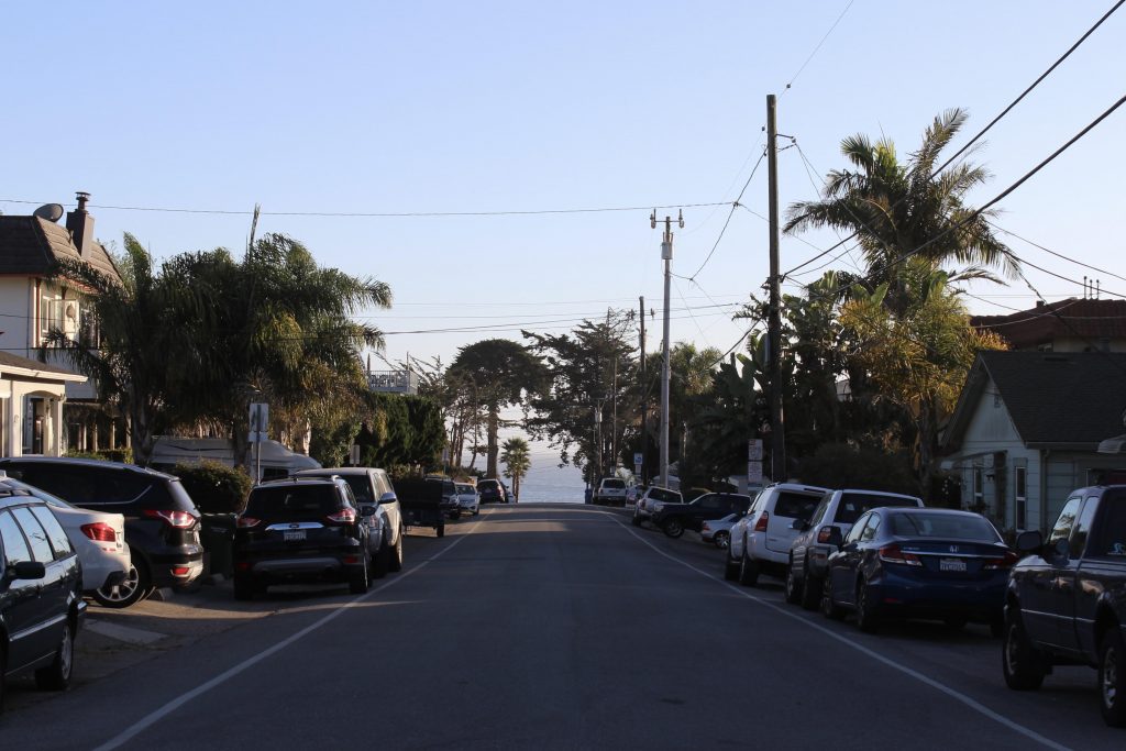 View down a street leading to the ocean.