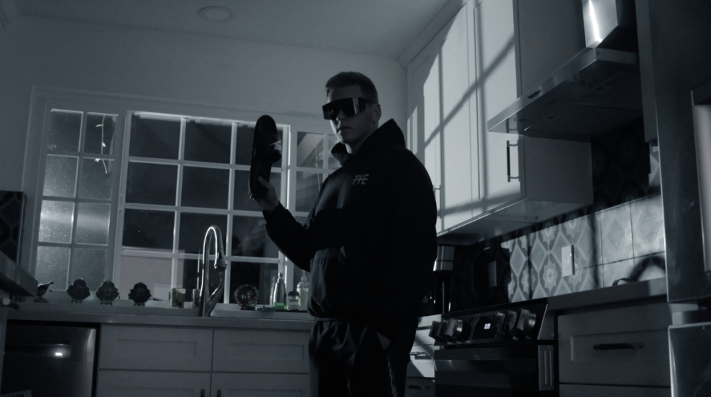 Man in all black, sunglasses, ready to strike his target.