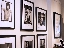 Spread of photos along a wall of the SFAE gallery