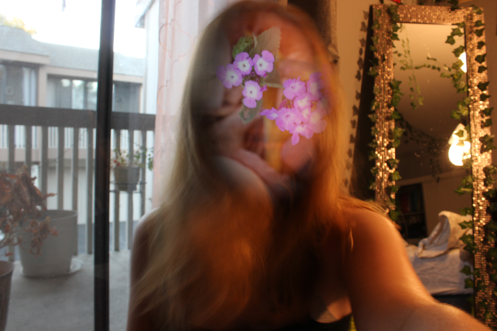 A girl with flowers in the place of her facial features