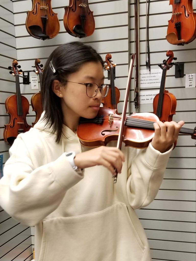 A picture of me playing a tiny violin