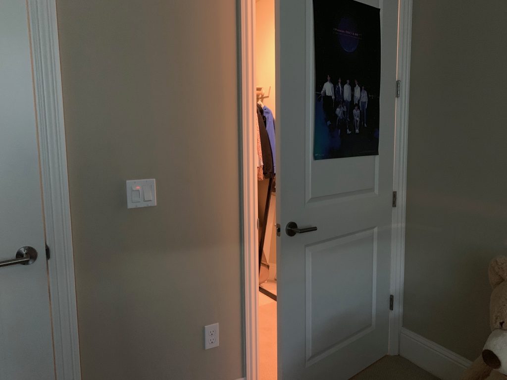 Photo of a self-portrait showing a door that is almost closed and a little light coming out.