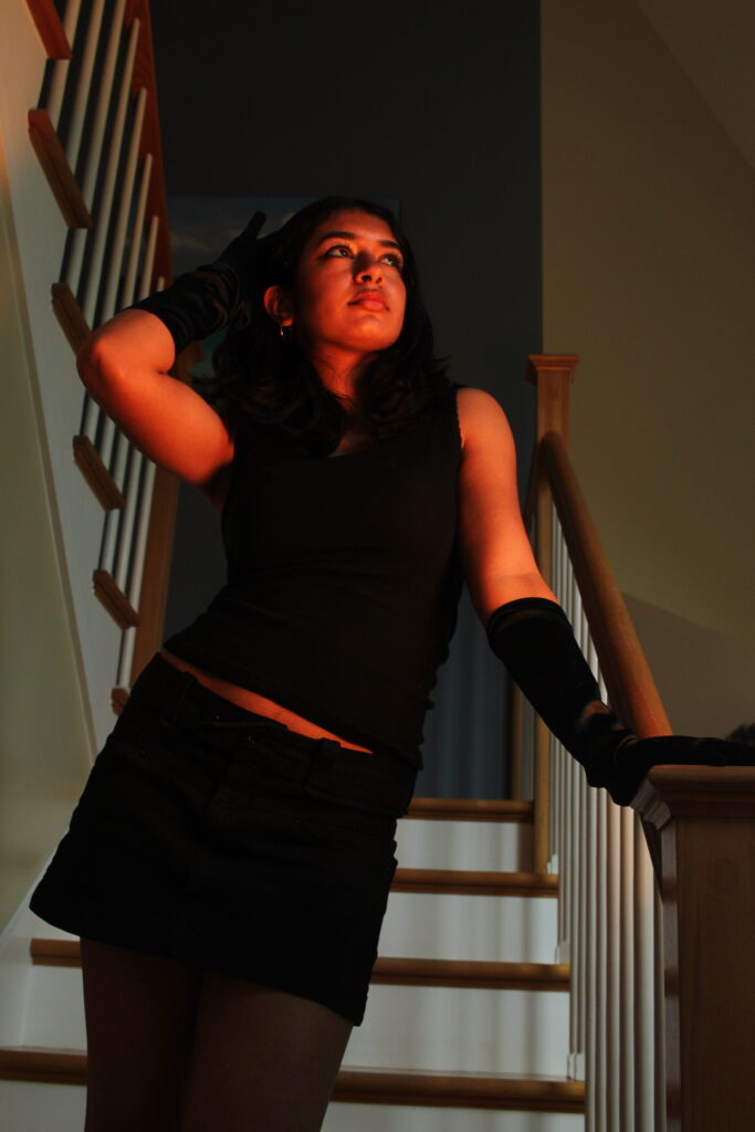 Model posed on staircase , Illuminated by orange light